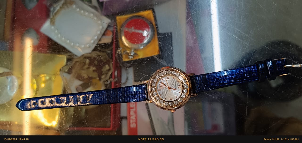 Radiant Splendor: Blue Strap Ladies Watch with Gold Round Dial and Shimmering Stone Accents"